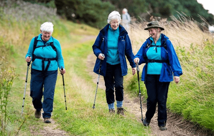 three people outdoors, on a walk