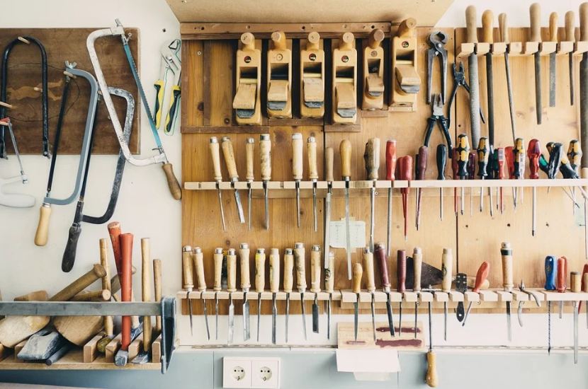 tools hanging on the wall, various tools, wood wall