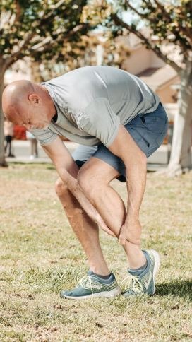 An older man experiencing joint cramp