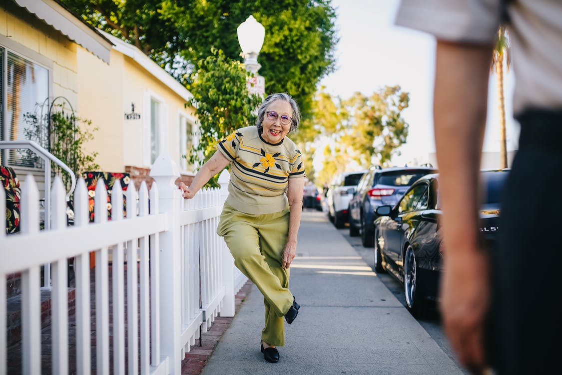 elderly woman fixing her shoes