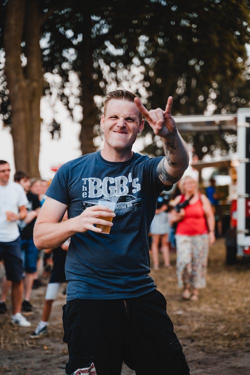 a man doing a rock and roll sign