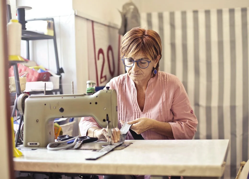 a woman using a sewing machine