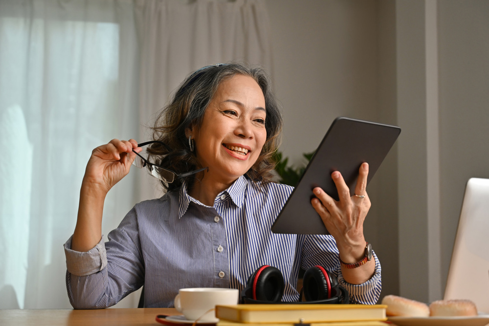 Portrait with Old senior host radio reading news on tablet before starting broadcast