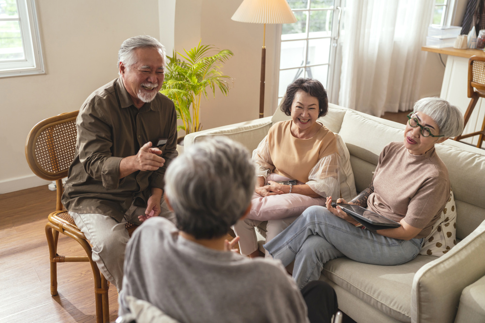 Old senior asian friends retired people hapiness positive laugh smile conversation together at living room at nursing home Seniors participating in Group Activities in Adult Daycare Center