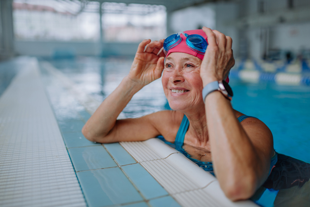 A happy senior woman in a swimming pool